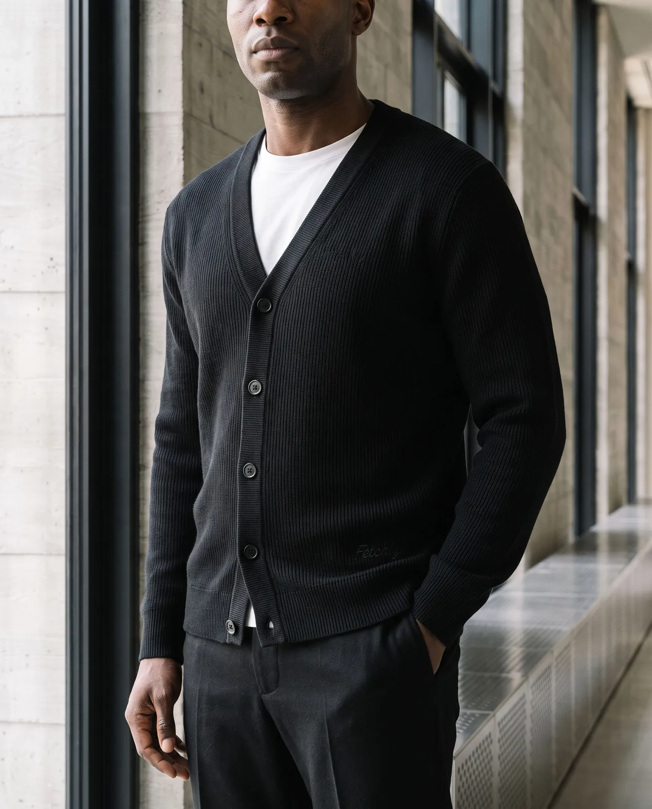Close crop of the black cardigan, hands in pockets