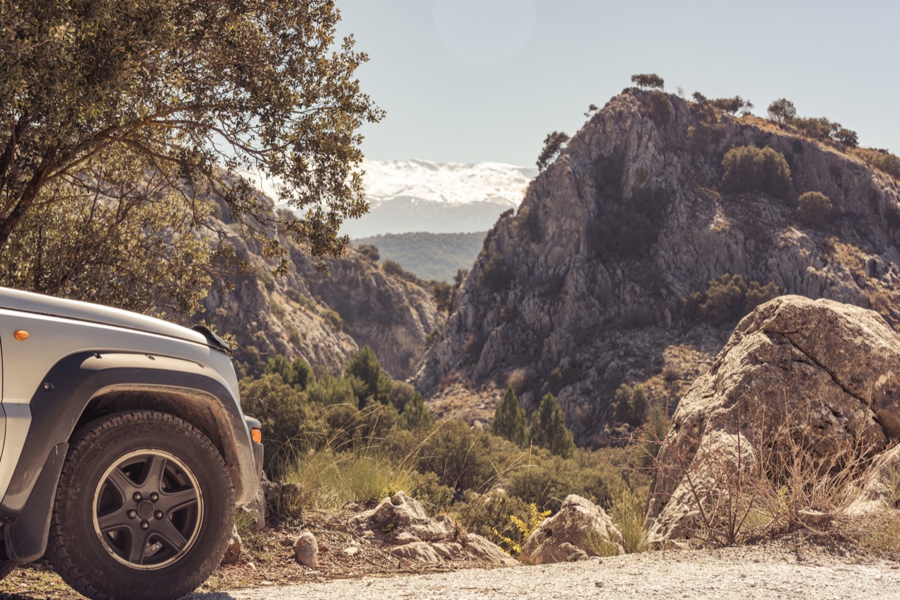 An SUV parked on a mountain road